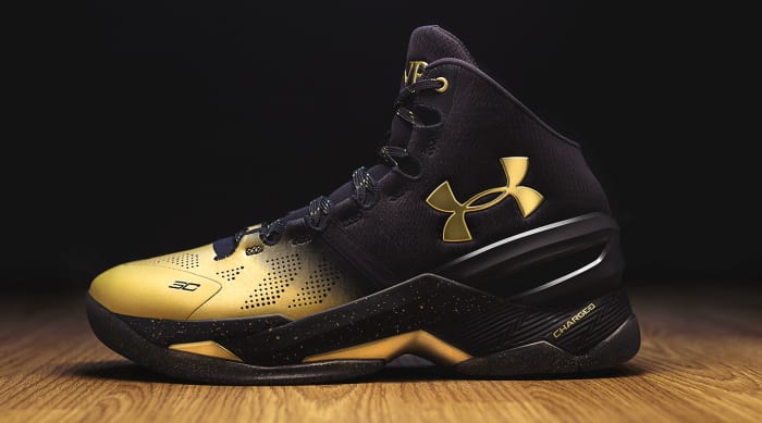 Side view of Stephen Curry's black and gold Under Armour shoe.